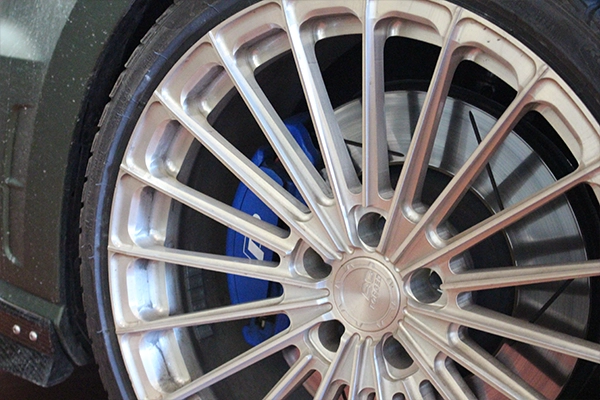 Silver wheel with blue brake calipers