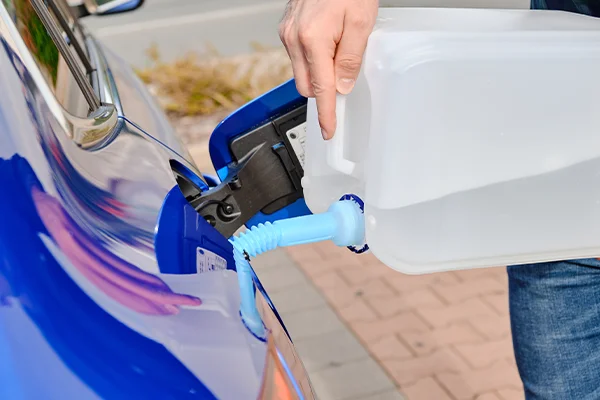 Man filling up diesel exhaust fluid