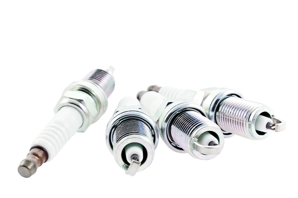 Spark plugs sitting on white background
