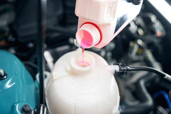 coolant being poured into engine
